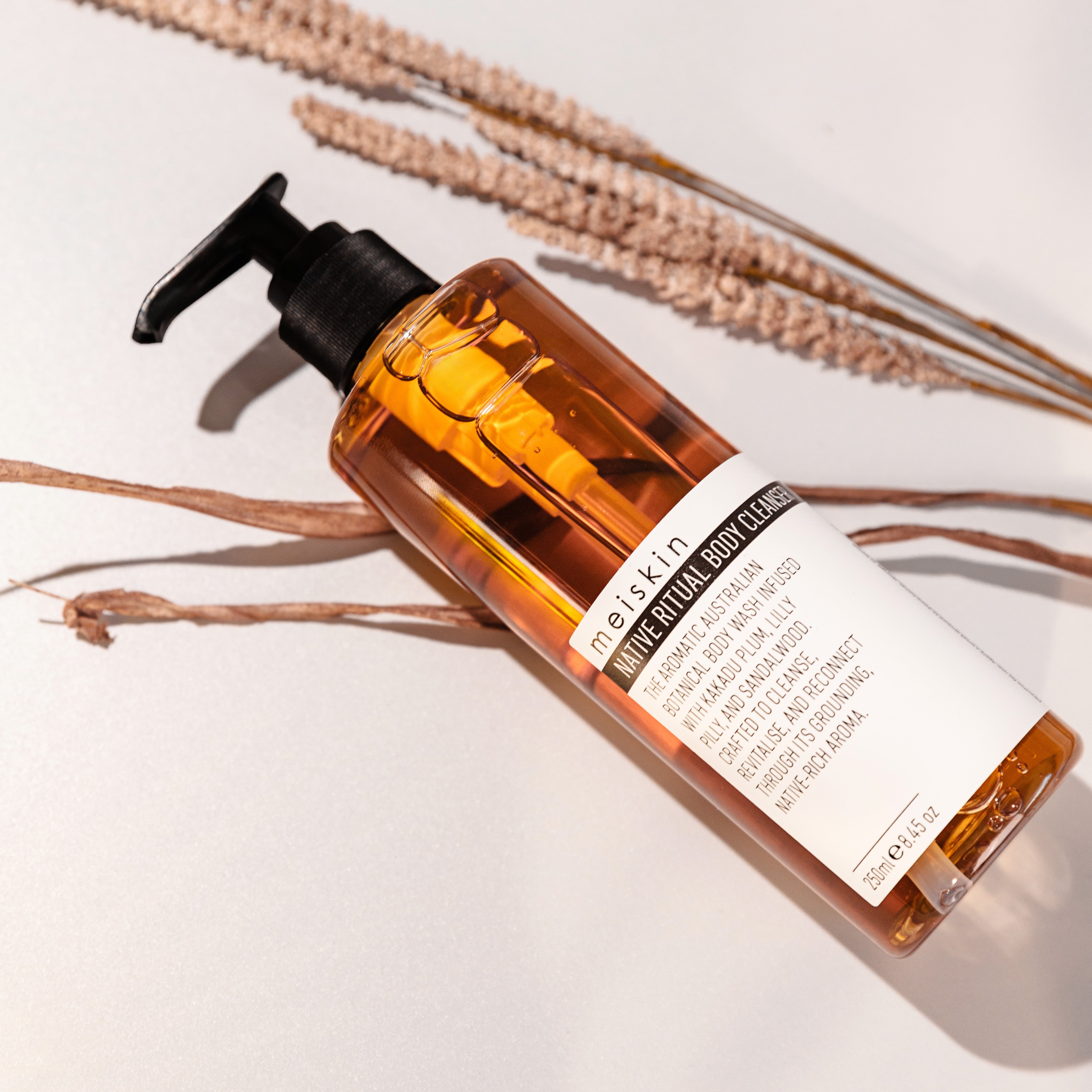 Bottle of body cleanser with a label on a light background