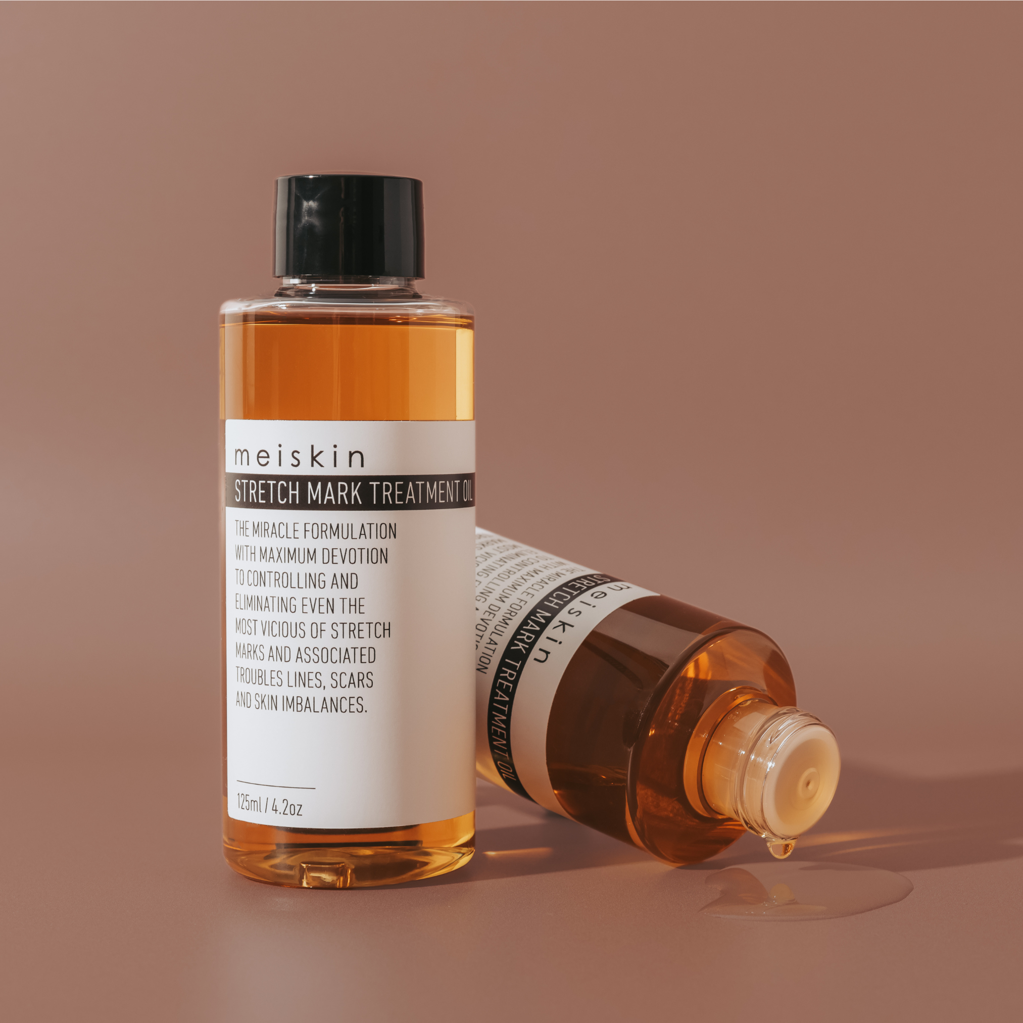 Meiskin Stretch Mark Treatment Oil – clear glass bottle with black lid, natural skincare for scars, stretch marks, and skin healing, made in Australia. Visible results in weeksd